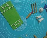 A picture of step 11 of Cricket 🏏 theme cake.