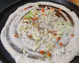 A picture of step 4 of Owar cheese pizza dosa with tomato onion chutney gravy.