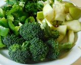 A picture of step 1 of Multi colored pilaf with broccoli, red and orange bell peppers, and carrots.