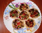 A picture of step 5 of Sev puri chaat 🧄🌶️🍅🧅🍋.