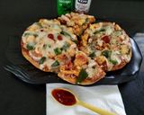 A picture of step 11 of Paneer Naan Pizza.