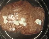 A picture of step 2 of Flank Steak on a bed of Onions.