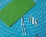 A picture of step 11 of Cricket 🏏 theme cake.