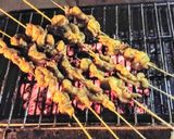 A picture of step 9 of Chicken paprika drums Skewered red hot Shrimps and grilled sausages.