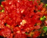 A picture of step 4 of Shakshuka (In my style- Poached eggs in tomato and veggie gravy).