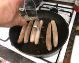 Foto del paso 2 de la receta: Salchichas cocidas con vino patatas fritas y huevo frito