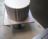 A picture of step 5 of 8 inch tall chocolate brownie cake.