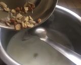 A picture of step 3 of Kesari Rasmalai topping with crunchy nuts.