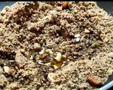 A picture of step 4 of Wheat flour seeds and nuts Ladoo with leftover ghee residue.