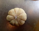 A picture of step 11 of Pumpkin shaped dinner rolls.