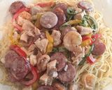 A picture of step 5 of Chicken, Shrimp, & Sausage with Alfredo Sauce on Angle Hair Pasta.