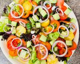 A picture of step 3 of Greek salad with shrimps.