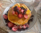 A picture of step 3 of Pancakes with loads of fruits and honey.