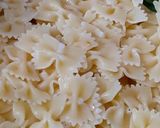 A picture of step 4 of Farfalle Pasta with cheese & Schezwan sauce.