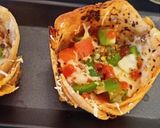 A picture of step 4 of Leftover Roti basket pizza.