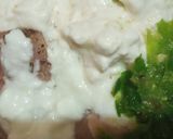 A picture of step 2 of Malai boti pizza with white sauce.
