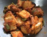 A picture of step 7 of Chatpata Bread Upma in red sauce.