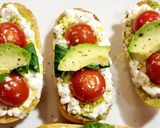 A picture of step 8 of Toasts with Cottage Cheese, Cherry Tomatoes, Guacamole, and More.