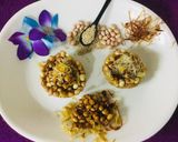 A picture of step 13 of Caramalized peanuts in peanuts-sesame Katoris garnished with spun sugar.