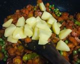 A picture of step 2 of Alu matar gaajar.