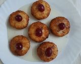 A picture of step 5 of Coconut fritters deep in sugar syrup.