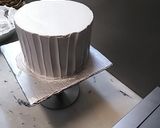 A picture of step 5 of 8 inch tall chocolate brownie cake.