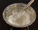 A picture of step 9 of Vanilla Butter Cakes filled and Frosted with Whipped White Chocolate Rasberry Ganache.