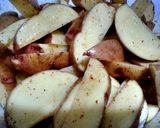 A picture of step 3 of Spicy baked potatoes wedges.