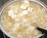 A picture of step 6 of Miso soup with tofu, daikon, onion.
