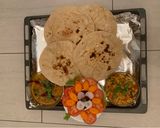 A picture of step 35 of Cauliflower Sabzi,Daal fry, Naan(wheat flour),Jeera rice,Salad and papad.