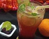 A picture of step 3 of Mulberry Orange Sunset layered Mocktail.