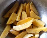A picture of step 1 of Baked Irish Potatoes and peppered chicken.