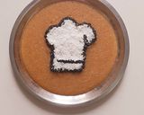 A picture of step 9 of Rava kesari with dessicated coconut and toasted sesame.