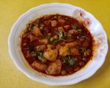 A picture of step 3 of Masala laccha paratha with aloo matar in tomato gravy.