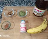 A picture of step 1 of Banana Moringa Yakult Milkshake topped with Walnuts.