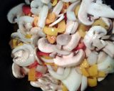 A picture of step 6 of curry mushrooms and peppers in a sauce.