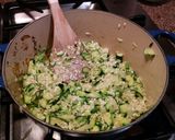 A picture of step 4 of Risotto with thick slices of zucchini.