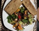 A picture of step 10 of Filling healthy dinner: salmon salad with horsradish dressing and garlic bread on the side.