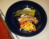 A picture of step 12 of Sticky Asian pork ribs with grilled asparagus over red wine feta aioli.