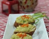 A picture of step 5 of Moong and Chana Hummus on toasted bread.