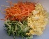 A picture of step 4 of Sunomono-Style Carrot, Cucumber, and Egg Salad.