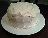 A picture of step 11 of White Butter Cake layered with Raspberry Cream with a White Chocolate Frosting.