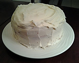A picture of step 11 of White Butter Cake layered with Raspberry Cream with a White Chocolate Frosting.