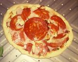 A picture of step 4 of Tex's 2 Pig Pizza 🍅🐷🧀🍕🌿.
