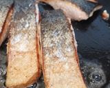 A picture of step 3 of Pan fried salmon on an open jacket with dill and butter.