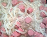 A picture of step 5 of Udon noodles with egg and Vienna sausages.