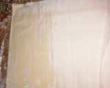 A picture of step 3 of Samsa with pastry sheets stuffed with almonds.