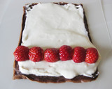 A picture of step 13 of Cocoa Crepe Roll Cake with Whole Strawberries.