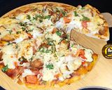 A picture of step 9 of Cheese Burst Veggies And Chicken Pizza From Scratch.