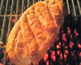 A picture of step 5 of Oval Cheese and Tomato Braai Bread.